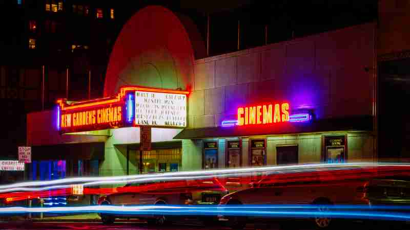 Vibrant night view of New Gardens Cinemas in Queens, New York with colorful neon lights and light streaks., tags: für - pexel